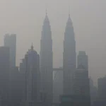 Pemandangan kabut asap pekat menyelimuti kawasan permukiman dan gedung perkotaan